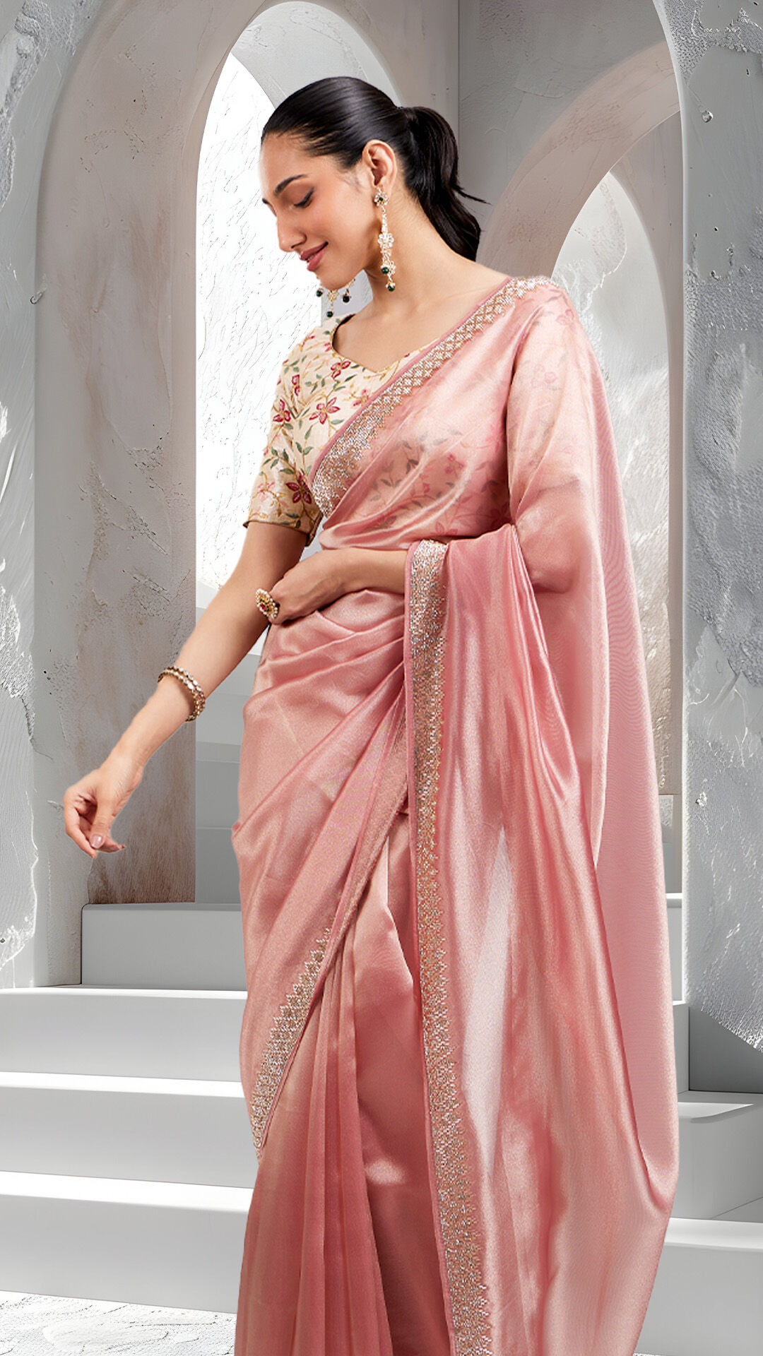 Modern pink saree styled with minimal accessories for a contemporary look
